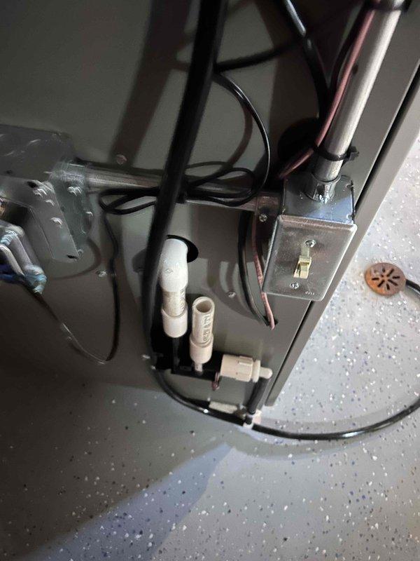 # HVAC Complete System Installation

Successfully completed a full HVAC system installation including both interior and exterior components. Installed new air handler unit in mechanical room on concrete pad with proper drainage provisions. Routed and secured copper refrigerant lines, electrical conduit, and condensate drainage lines throughout the installation. Mounted exterior condensing unit on building with appropriate line set penetrations through vinyl siding. Installed white PVC condensate drain lines with proper pitch and termination points at building exterior. Connected all electrical components including junction boxes and power supply conduit. Secured all refrigerant lines with proper insulation and bundling. Installed Amtrol expansion tank and associated plumbing connections. Completed all refrigerant line connections, pressure testing, and system evacuation. Energized system and verified proper operation of all components including heating and cooling cycles. All installat