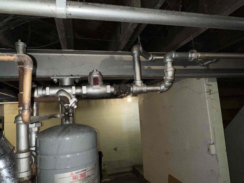 Conducted comprehensive assessment of existing HVAC system and mechanical infrastructure for replacement estimate. Evaluated current heating and cooling equipment configuration, including inspection of mechanical room plumbing connections, expansion tank installation, and associated piping systems. Documented electrical service panel specifications and capacity to determine compatibility requirements for new HVAC equipment installation.