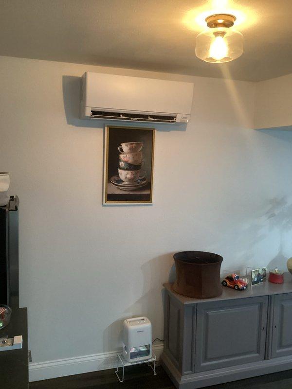 Completed installation of ductless mini-split air conditioning system in residential living space. Mounted indoor evaporator unit on interior wall at optimal height for air distribution, installed refrigerant line set through wall penetration, and positioned outdoor condenser unit with proper clearances. System was pressure tested, evacuated, charged with refrigerant, and successfully commissioned with all operational parameters verified within manufacturer specifications.