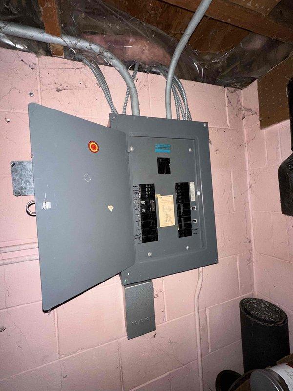 Completed comprehensive HVAC system evaluation in residential basement utility area for full equipment replacement estimate. Assessed existing furnace and air handler configuration, documented current electrical panel capacity and conduit routing, evaluated ductwork connections and plenum mounting, and photographed equipment layout to provide detailed replacement recommendations and specifications for new high-efficiency heating and cooling system installation.