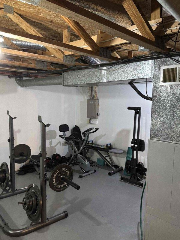 Conducted comprehensive assessment of existing HVAC system in residential basement installation for equipment replacement estimate. Documented current electrical service configuration at main breaker panel, noting circuit distribution for heating system integration and verifying adequate electrical capacity for new equipment installation. Evaluated existing ductwork layout in finished basement area, including flexible and rigid metal duct runs throughout exposed ceiling joists, to determine compatibility with replacement system specifications and identify any necessary modifications for optimal airflow distribution.