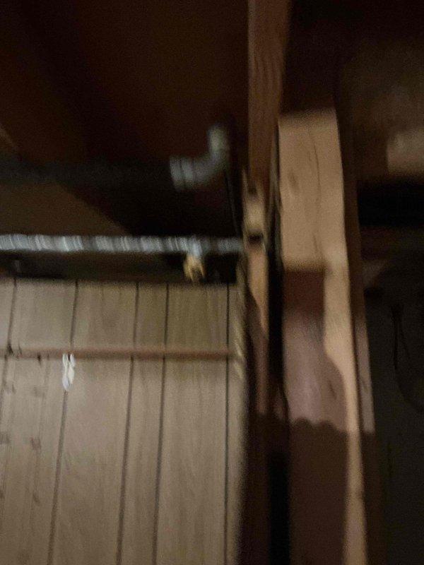 Completed installation of tankless water heater system including assessment of existing natural gas supply infrastructure and utility connections. Documented pre-installation conditions showing gas meter assembly with corroded piping sections requiring evaluation for adequate gas supply capacity. Performed installation work in basement utility area involving structural access and integration with existing plumbing infrastructure to accommodate new tankless unit.