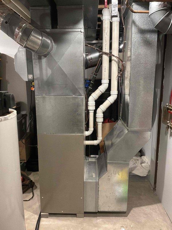 Completed comprehensive HVAC system replacement in residential basement mechanical room, installing new air handler unit with associated ductwork, drainage piping, and electrical connections. Configured galvanized steel ductwork transitions in attic space with proper sealing and integrated refrigerant line routing to ensure optimal airflow distribution throughout the home. All components installed per manufacturer specifications with condensate drainage system properly positioned and secured for reliable long-term operation.