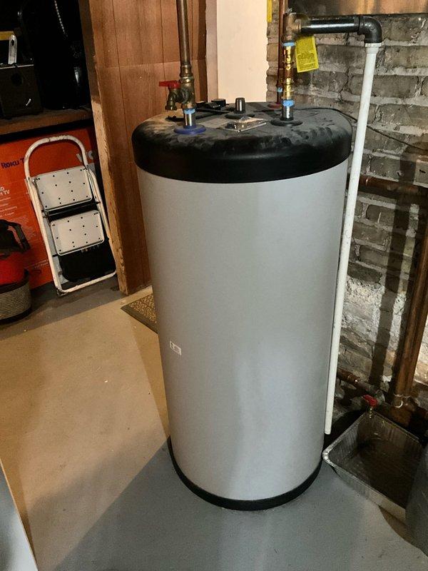 Conducted comprehensive assessment of existing basement heating system and water heater installation. Documented current HVAC equipment configuration including air handler unit with control systems, exposed copper supply and return piping with shut-off valves, and PVC condensate drainage. Evaluated water heater condition and plumbing connections, noting all mechanical components, valve locations, and system integration points for preparation of boiler replacement estimate.