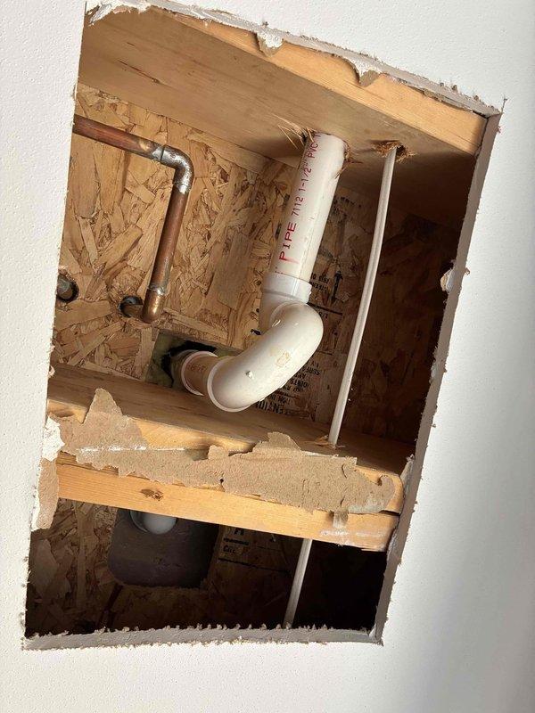 Completed installation of new plumbing rough-in for toilet fixture, including copper water supply lines and PVC drain/vent piping within wall cavity. Inspected and verified proper operation of existing sump pump system in basement basin, confirming discharge line connection and pump functionality with adequate water removal capability.