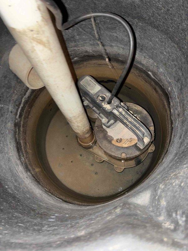 Completed installation of new plumbing rough-in for toilet fixture, including copper water supply lines and PVC drain/vent piping within wall cavity. Inspected and verified proper operation of existing sump pump system in basement basin, confirming discharge line connection and pump functionality with adequate water removal capability.