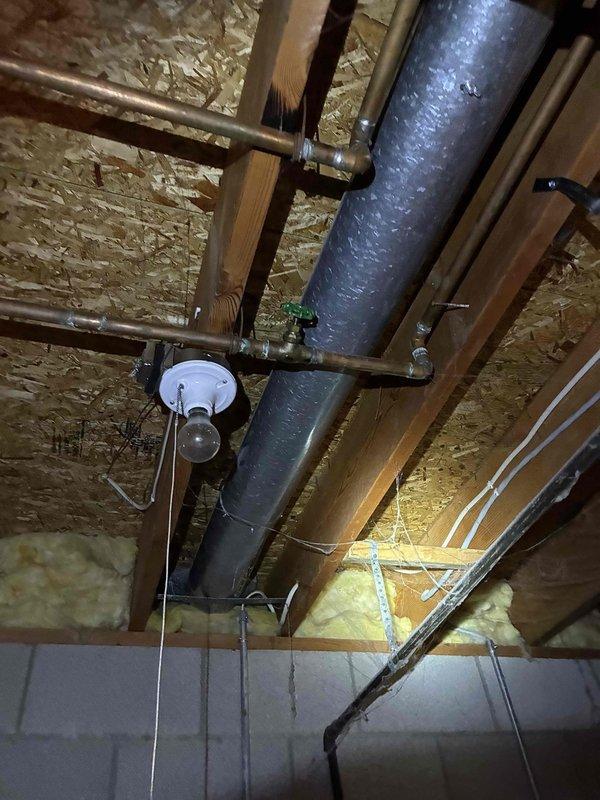 Completed furnace inspection and system evaluation in residential basement mechanical area. Documented existing HVAC infrastructure including ductwork routing, supply and return air distribution systems, and equipment accessibility. Verified proper clearances around heating equipment and assessed overall mechanical room conditions. Insulated ductwork and copper plumbing lines were observed in good condition with appropriate mounting and support throughout the ceiling joists. All utility connections and structural installations were found to be properly secured and functioning as designed.