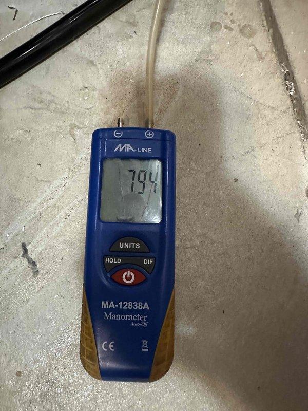 Completed furnace installation with full system commissioning and pressure testing. Used digital manometer to verify gas pressure readings, measuring manifold pressure at 794 units initially and confirming final operating pressure at 116.5 units to ensure proper gas valve operation and burner performance within manufacturer specifications. All pressure readings documented and system verified for safe, efficient operation.