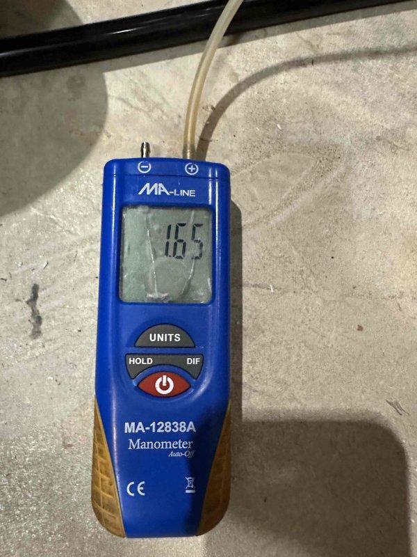 Completed furnace installation with full system commissioning and pressure testing. Used digital manometer to verify gas pressure readings, measuring manifold pressure at 794 units initially and confirming final operating pressure at 116.5 units to ensure proper gas valve operation and burner performance within manufacturer specifications. All pressure readings documented and system verified for safe, efficient operation.