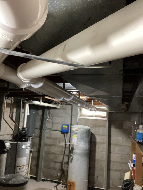 Performed comprehensive HVAC tune-up on residential furnace system. Conducted thorough inspection of internal components including blower motor, heat exchanger, ignition system, and control board. Removed front access panels to access both upper and lower compartments, tested electrical connections and circuitry using multimeter to verify proper voltage and amperage readings. Inspected PVC intake and exhaust vent pipes for proper installation and clearance. Examined ductwork connections and insulation throughout basement area, verified all mechanical linkages and wiring harnesses were secure and functioning correctly. All systems tested and operating within manufacturer specifications upon completion.