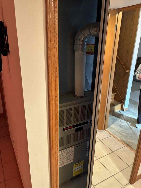 Conducted comprehensive duct cleaning estimate for residential HVAC system featuring a Trane furnace unit installed in interior closet space. Inspected accessible ductwork including flexible metallic supply ducts and rigid metal return plenum, assessed accumulation levels within visible duct sections and around blower assembly, and photographed system configuration to document current conditions. Provided homeowner with detailed scope of work recommendations for complete air distribution system cleaning including supply and return ductwork, register removal and cleaning, and blower compartment sanitation.