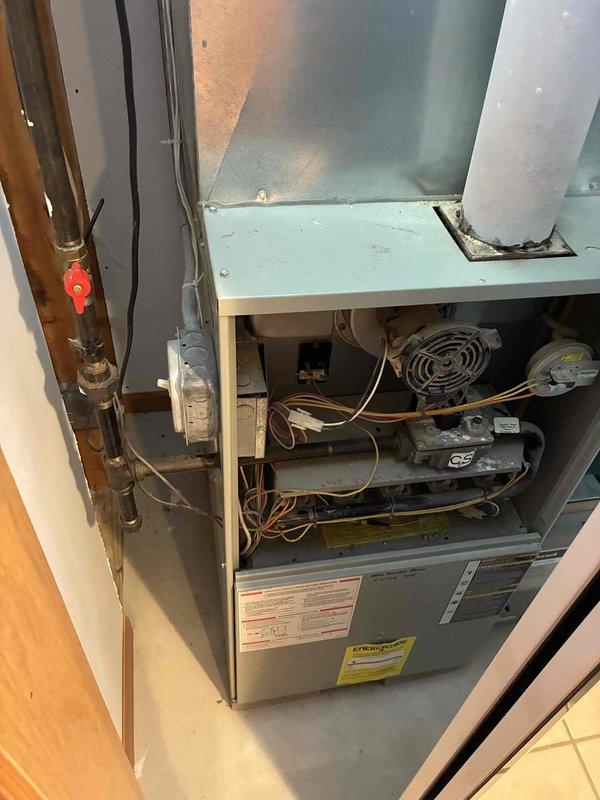 Conducted comprehensive duct cleaning estimate for residential HVAC system featuring a Trane furnace unit installed in interior closet space. Inspected accessible ductwork including flexible metallic supply ducts and rigid metal return plenum, assessed accumulation levels within visible duct sections and around blower assembly, and photographed system configuration to document current conditions. Provided homeowner with detailed scope of work recommendations for complete air distribution system cleaning including supply and return ductwork, register removal and cleaning, and blower compartment sanitation.