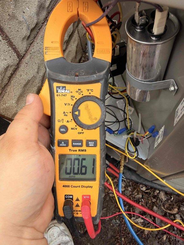 # HVAC Install - System Start Up

Completed system start-up and commissioning of newly installed HVAC equipment. Verified all electrical connections and measured operating amperage at 6.1 amps on the outdoor unit, confirming proper current draw within manufacturer specifications. Inspected capacitor installation and wiring connections, ensuring secure mounting and proper color-coded wire terminations. System tested under partly cloudy conditions with ambient temperature of 70°F, providing ideal circumstances for baseline performance verification. All components energized successfully and unit operating as designed.