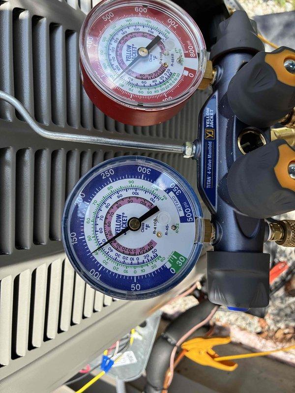 # HVAC Install - System Start Up

Completed installation and system start-up procedures for new HVAC equipment. Connected manifold gauge set to service ports and verified refrigerant pressures on both high and low sides of the system. Measured operating pressures using Yellow Jacket diagnostic gauges, confirming readings were within manufacturer specifications for proper system operation. Inspected condenser coil and heat exchanger components for proper installation and clearance. Verified all electrical connections and wiring were secure and properly terminated. System tested and confirmed operational with appropriate superheat and subcooling values achieved.