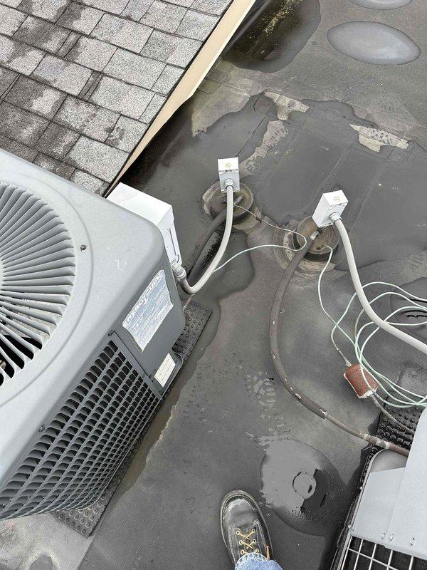 Conducted comprehensive site assessment for complete HVAC system replacement at residential property. Evaluated existing rooftop condensing unit showing significant age-related deterioration, with weathered electrical conduit and wiring requiring upgrade to current code standards. Documented condition of rubberized membrane roofing surface displaying moderate wear and water staining around equipment mounting area. Assessed interior ductwork configuration including flexible metallic ducts and junction components in ceiling plenum space. Provided detailed replacement estimate covering new high-efficiency condensing unit installation, upgraded electrical disconnect and wiring, proper equipment mounting with roof penetration sealing, and integration with existing duct distribution system to ensure optimal airflow and system performance.