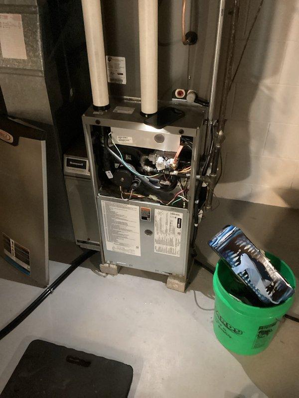 Responded to service call for gas furnace maintenance. Removed front access panel to inspect internal components and perform necessary repairs. Replaced furnace control board or module, which required disconnecting wiring harnesses and removing old component from housing. Installed new white-framed control board, ensuring proper fitment and secure mounting. Reconnected all electrical connections and verified proper wire routing. Tested furnace operation to confirm successful repair. Reinstalled access panel and left unit in proper working condition.