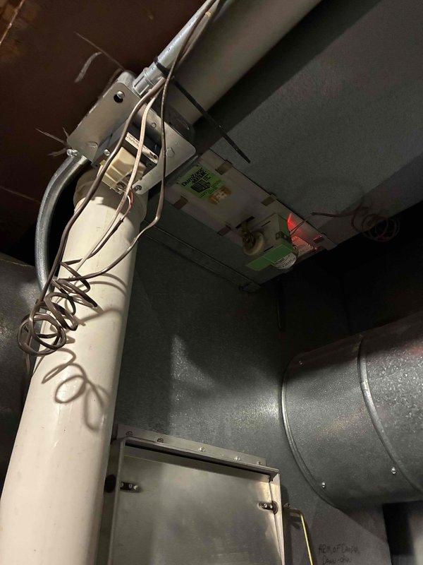 Completed furnace inspection and system evaluation in mechanical room. Documented HVAC equipment installation including air handler unit, ductwork configuration, and associated mechanical components. Verified proper mounting of equipment, inspected duct connections and sealing, and examined electrical wiring routing throughout the ceiling joists to ensure compliance with installation standards.