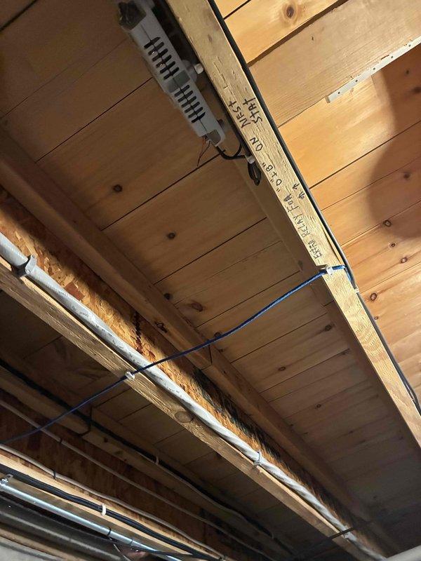 Completed furnace inspection and system evaluation in mechanical room. Documented HVAC equipment installation including air handler unit, ductwork configuration, and associated mechanical components. Verified proper mounting of equipment, inspected duct connections and sealing, and examined electrical wiring routing throughout the ceiling joists to ensure compliance with installation standards.