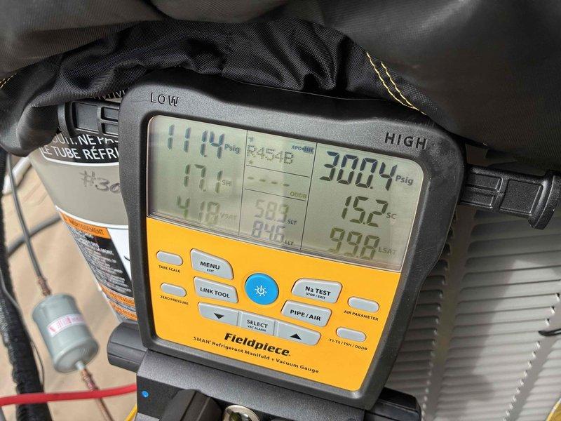 Completed HVAC system installation and startup procedures. Performed system commissioning using digital manifold gauges to verify refrigerant pressures and temperatures, confirming proper charge levels with readings of 114 PSIG on the low side and 300+ PSIG on the high side at 152°F. Programmed and tested Nest smart thermostat, setting cooling setpoint to 70°F with system responding appropriately to reach target temperature.