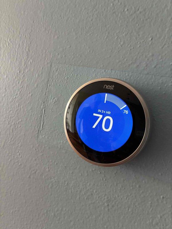 Completed HVAC system installation and startup procedures. Performed system commissioning using digital manifold gauges to verify refrigerant pressures and temperatures, confirming proper charge levels with readings of 114 PSIG on the low side and 300+ PSIG on the high side at 152°F. Programmed and tested Nest smart thermostat, setting cooling setpoint to 70°F with system responding appropriately to reach target temperature.