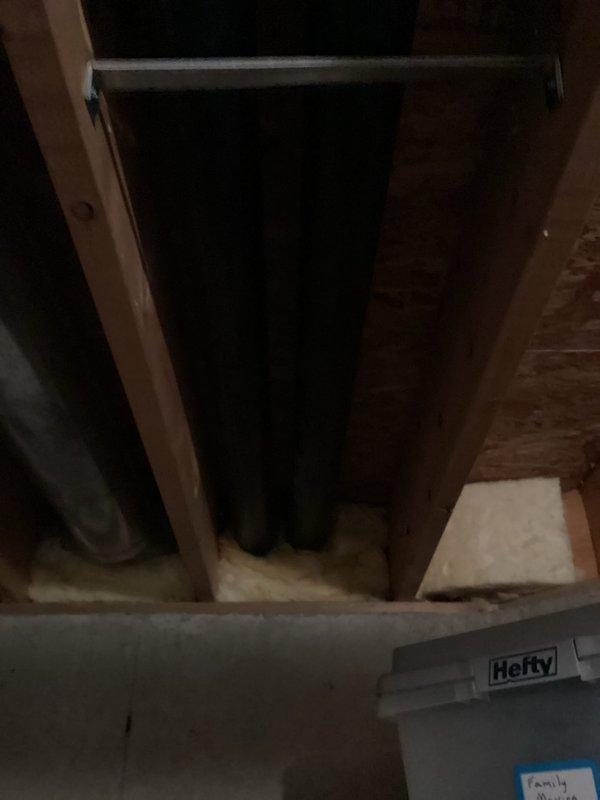 Completed HVAC system installation in residential property including new air handler unit and associated components. Installed black cylindrical air handler in basement mechanical room with proper connections to existing ductwork and electrical systems. Routed refrigerant lines and condensate drainage per manufacturer specifications. Verified all mechanical connections, tested system operation, and confirmed proper airflow throughout the residence. Installation includes integration with existing water heater and plumbing infrastructure. All equipment secured and labeled according to code requirements. System tested and operational upon completion of warranty work.