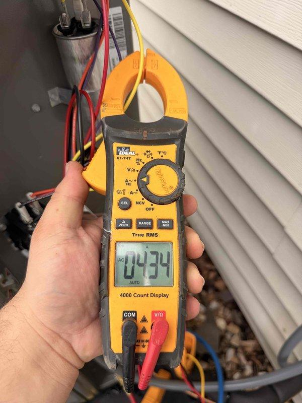 Completed system start-up and commissioning of newly installed HVAC equipment. Performed electrical diagnostics using clamp meter to verify proper amperage draw and system performance, recording 4.34 amps at the outdoor unit. Inspected all electrical connections at the control panel, confirmed proper wire terminations at terminal blocks and relays, and verified all safety controls were functioning correctly.