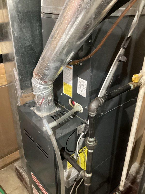 # HVAC Service Report - No Cooling Issue

Responded to a no cooling call on a 10+ year old residential HVAC system. Upon arrival, performed a comprehensive system evaluation of both the indoor furnace unit and outdoor condensing unit. 

Inspected the basement-mounted furnace, noting the condition of the supply ductwork and verifying proper gas line and condensate drainage connections. Proceeded to the outdoor condenser unit where the top grille was removed to access internal components. Examined the condenser fan motor and blade assembly for proper operation. Inspected the refrigerant lines, including the suction and liquid lines, and evaluated the filter drier condition.

Given the age of the system (10+ years), performed diagnostic testing to identify the root cause of the cooling failure. Checked electrical connections, capacitor function, and compressor operation. Assessed refrigerant charge levels and system pressures to determine if refrigerant loss or mechanical failure was cont