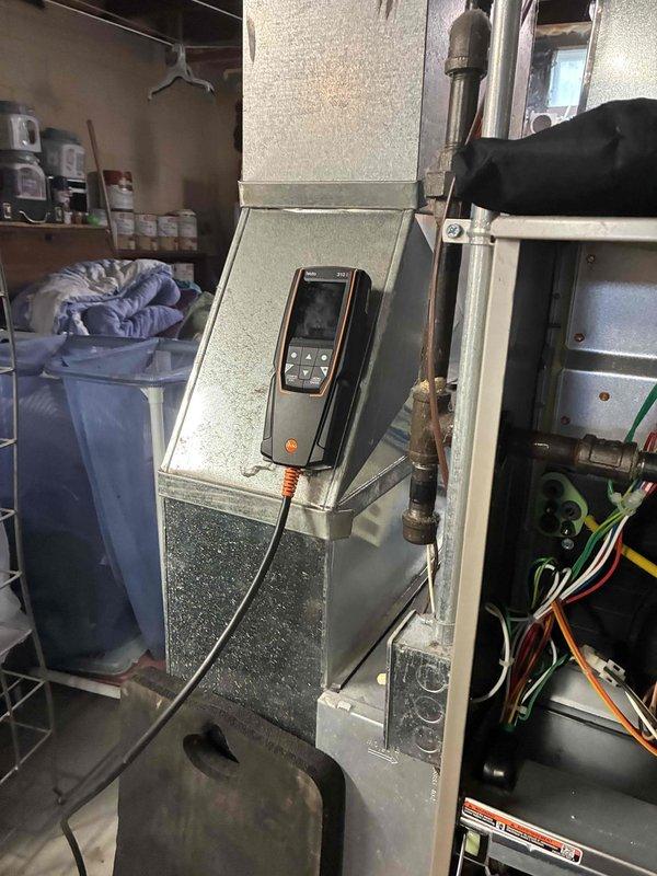 Completed comprehensive tune-up and performance evaluation on residential HVAC system. Performed diagnostic testing using calibrated digital instrumentation to verify system operation, inspected control wiring and electrical connections within air handler unit, and confirmed proper functionality of both the LASKO outdoor temperature control panel and digital thermostat displaying accurate temperature and humidity readings at 70°F and 67% respectively.