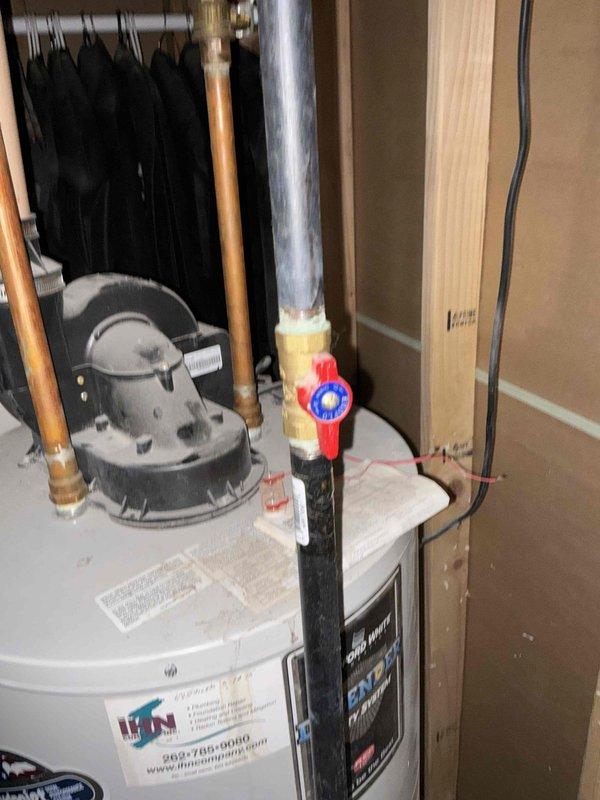 Completed comprehensive HVAC system evaluation for equipment replacement estimate in residential mechanical room. Assessment included existing water heater installation with aged copper piping connections, PVC vent system, and adjacent air handler unit positioned in confined utility space. Documented current plumbing infrastructure showing mixed materials including copper supply lines with brass fittings, black steel piping with foam insulation, and pressure relief components. Evaluated mechanical room configuration with concrete block wall construction and equipment accessibility for future replacement considerations. Photographed existing system components, pipe routing, and spatial constraints to provide accurate replacement specifications and installation planning recommendations.
