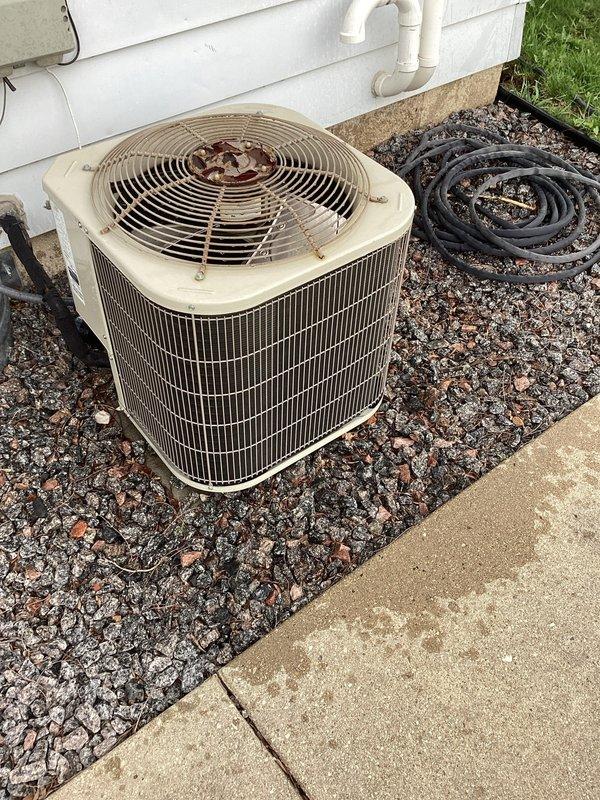 # HVAC No Cooling Service Call

Responded to a no cooling complaint on a residential air conditioning system less than 10 years old. Upon arrival, performed diagnostic assessment of the outdoor condensing unit and indoor air handler components. Utilized digital thermometer to measure supply air temperature, which registered 63.2°F, indicating inadequate cooling performance. 

Conducted thorough inspection of the outdoor condenser unit, which showed signs of age-related wear including discoloration, corrosion on metal surfaces, and weathering on fan components. Examined electrical connections, refrigerant lines, and compressor operation. Verified proper airflow through condenser coil and confirmed fan motor functionality. Checked refrigerant charge levels and system pressures to determine if low refrigerant or other mechanical issues were affecting cooling capacity.

Inspected indoor evaporator coil and air handler for proper operation, airflow restrictions, and temperature differential