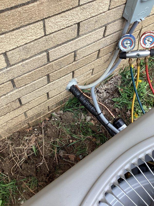 # HVAC Install - Complete System

Completed full HVAC system installation including indoor air handler unit and outdoor condensing unit. Installed new air handler in basement mechanical room with proper plenum connections and ductwork integration. Mounted outdoor condensing unit on exterior pad against building foundation with appropriate clearances. Ran and insulated refrigerant line set between indoor and outdoor units through building envelope. Installed electrical disconnect box at outdoor unit location per code requirements. Performed system startup procedures including refrigerant charging using manifold gauges to verify proper pressures and system operation. Tested all electrical connections, verified proper airflow through supply plenum, and confirmed heating and cooling functionality. System commissioned and operating within manufacturer specifications.