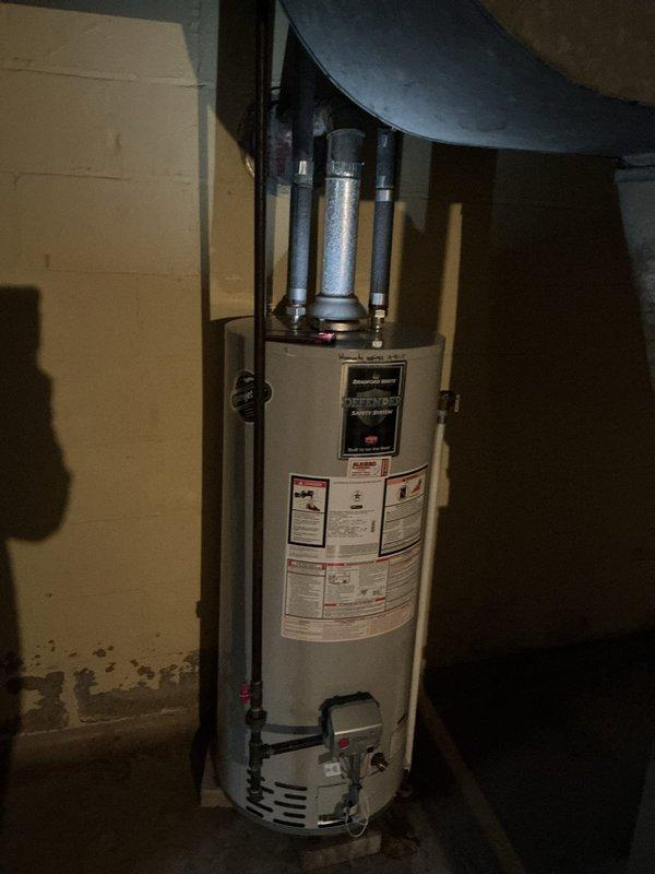 Serviced and inspected a State Water Heaters 50-gallon natural gas automatic storage water heater (Model GS6-50-NOIT, 40,000 BTU/hr input) installed in basement utility room. Documented unit condition, verified proper installation of plumbing connections and fittings at top and base of tank, and confirmed all manufacturer specification labels, safety warnings, and operating instructions are clearly visible and legible on unit exterior.