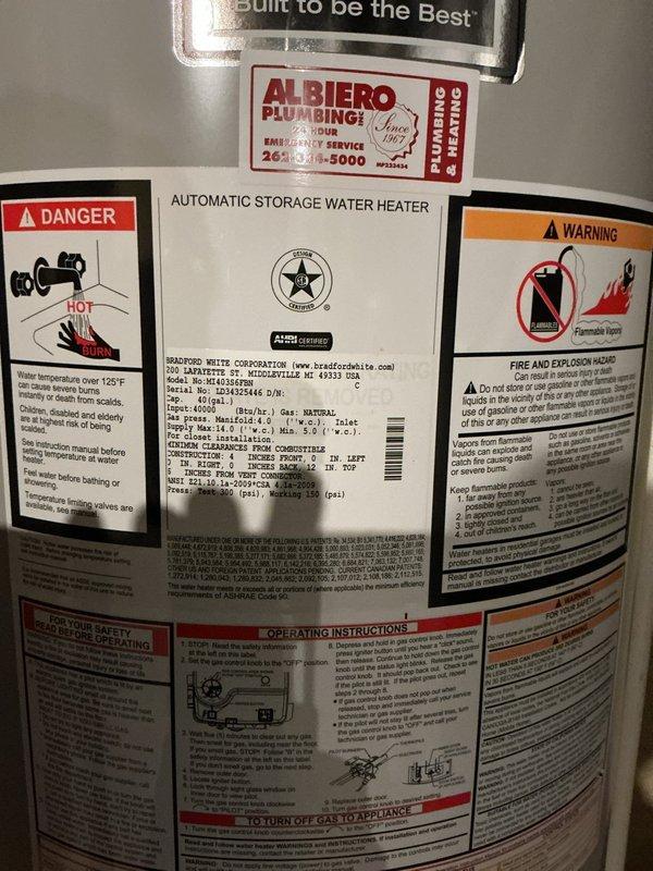 Serviced and inspected a State Water Heaters 50-gallon natural gas automatic storage water heater (Model GS6-50-NOIT, 40,000 BTU/hr input) installed in basement utility room. Documented unit condition, verified proper installation of plumbing connections and fittings at top and base of tank, and confirmed all manufacturer specification labels, safety warnings, and operating instructions are clearly visible and legible on unit exterior.