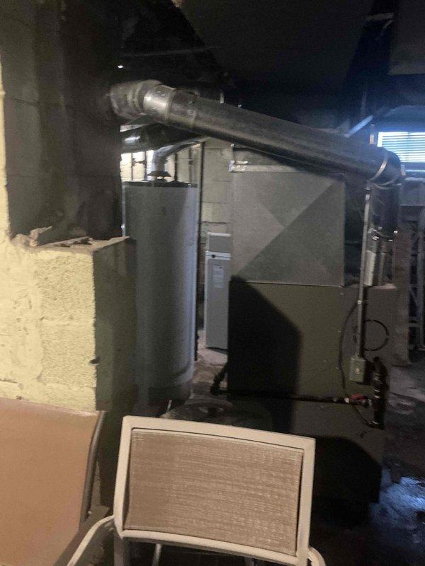 Completed comprehensive HVAC system assessment in basement utility area to provide replacement estimate. Evaluated existing furnace/air handler equipment, ductwork configuration including curved return air sections and cylindrical distribution ducts, and overall system layout for replacement specifications. Documented current equipment conditions, spatial constraints, and mechanical room infrastructure to develop accurate proposal for new HVAC system installation.