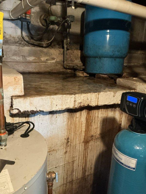 # Sump Pump Inspection and Service

Performed comprehensive inspection and service of existing sump pump system installed in basement utility area. Verified proper operation of submersible sump pump unit within circular pit equipped with black plastic liner set into concrete floor. Tested float switch mechanism for appropriate activation and deactivation at correct water levels. Confirmed secure attachment of float assembly to pump body and verified unobstructed movement throughout full range of motion.

Inspected white PVC discharge pipe for proper vertical alignment and secure mounting. Verified discharge pipe bracket and clamp assembly maintaining stable positioning. Examined two-piece sump pit cover for proper fit around discharge piping, ensuring adequate access for future maintenance while preventing debris entry into pit.

Assessed overall system functionality in conjunction with visible basement mechanical equipment, including pressure tank, water treatment systems, and associa