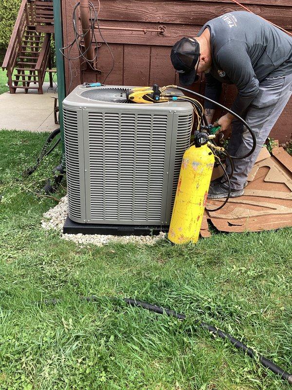 Completed installation of new air conditioning condenser unit and evaporator coil at residential property. Installed outdoor condensing unit on concrete pad with proper clearances, ran and insulated refrigerant line set along exterior wall, connected electrical components, and charged system with refrigerant to manufacturer specifications. System tested and verified operational with proper airflow and cooling performance.
