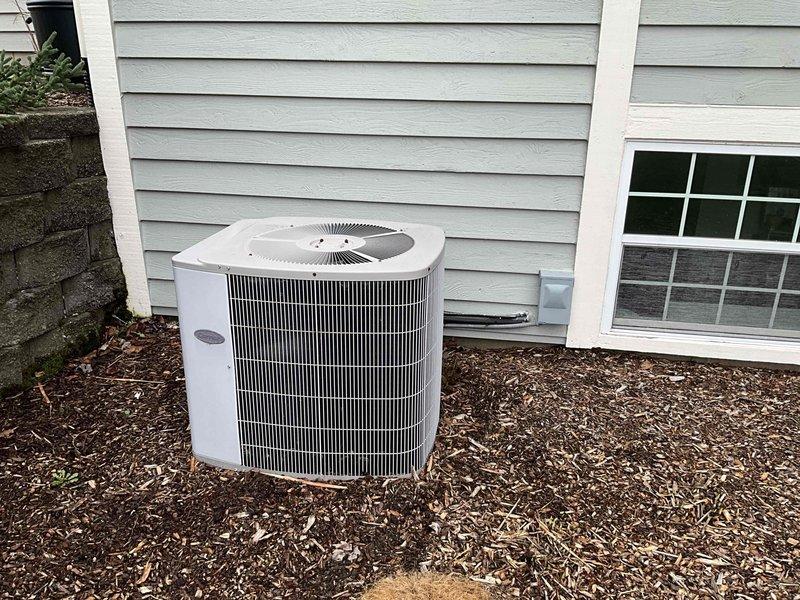 Completed comprehensive HVAC system evaluation for equipment replacement estimate. Assessed existing Carrier furnace unit in basement utility area and outdoor air conditioning condenser unit, documenting current equipment specifications, installation conditions, and system configuration including copper refrigerant lines, PVC condensate drainage, and venting components to provide accurate replacement recommendations and sizing requirements.