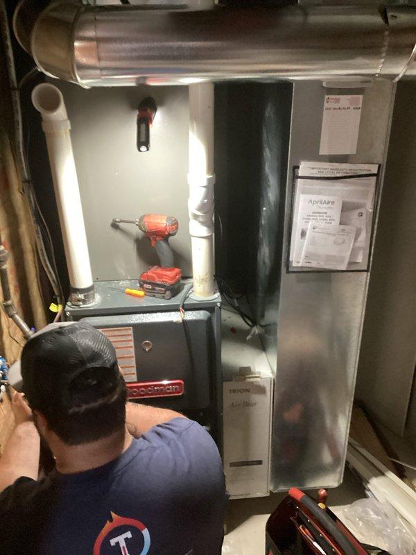 Completed HVAC system installation and startup in residential mechanical room. Installed Goodman furnace/air handler unit with proper PVC condensate drainage lines, metallic supply ductwork, and secondary air handling equipment. Verified all electrical connections, tested system operation, confirmed proper airflow through insulated ductwork penetrations, and ensured all equipment met manufacturer specifications for safe and efficient operation.