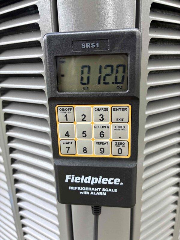 Completed system start-up for new HVAC installation. Verified refrigerant charge using calibrated digital scale, confirming proper weight of 120 ounces. Measured supply air temperature at 51.2°F at register, indicating system is cooling effectively and operating within manufacturer specifications.