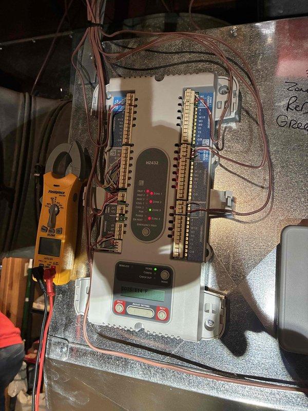 Performed diagnostic testing and inspection of HVAC system electrical controls and components. Utilized digital multimeter to verify proper voltage and amperage readings at the HZ432 control module and associated terminal connections. Inspected and documented the EYS Controls board mounted on the air handler unit, confirming all LED indicators functioning properly and digital display showing correct operational parameters. Verified all wire connections at terminal strips were secure and properly terminated, with no signs of overheating or damage to conductors. All system controls tested within manufacturer specifications and unit operating normally upon completion of service inspection.