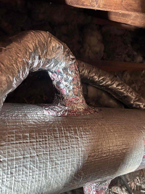 Installed flexible HVAC ductwork in attic space, including proper connection to copper pipe collar with metallic foil tape sealing at junction points. Routed insulated flex duct through structural framing members to ensure adequate airflow distribution throughout the system.