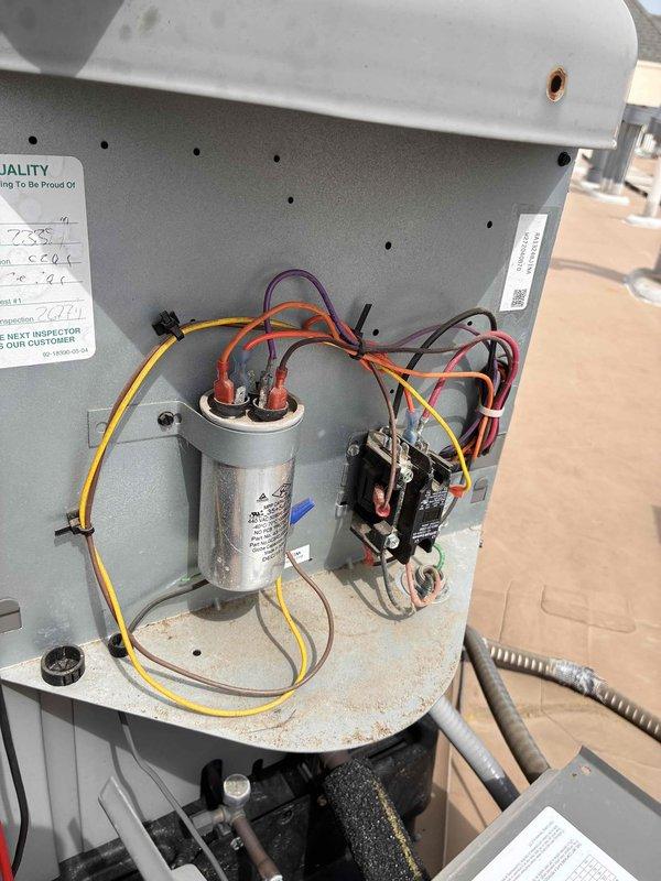 Completed preventative maintenance tune-up on residential HVAC system. Inspected and photographed air filter showing moderate dust accumulation on pleated media; filter remains serviceable but approaching replacement interval. Accessed condensing unit electrical compartment and inspected capacitor, contactor, and associated wiring connections; all components operating within normal parameters with secure wire terminations and no signs of electrical failure or overheating.