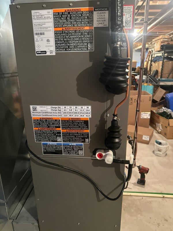 Completed full HVAC system installation in basement utility area, including new air handler unit with integrated auxiliary heating capabilities. Installed and secured all refrigerant lines, electrical connections, flexible ductwork transitions, and condensate drainage system per manufacturer specifications. System tested and verified operational with all safety labels and data plates properly affixed.
