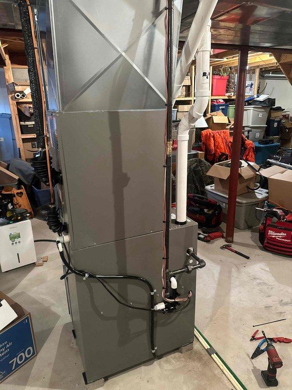 Completed full HVAC system installation in basement utility area, including new air handler unit with integrated auxiliary heating capabilities. Installed and secured all refrigerant lines, electrical connections, flexible ductwork transitions, and condensate drainage system per manufacturer specifications. System tested and verified operational with all safety labels and data plates properly affixed.