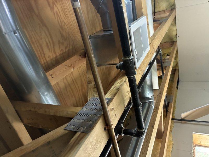 Conducted site assessment for washer and dryer installation requiring gas line, hot water supply valve, and drain connections. Evaluated existing mechanical space with exposed framing, identified routing paths for copper supply lines and PVC drainage, and documented current HVAC ductwork and utility infrastructure to provide accurate estimate for required plumbing modifications.