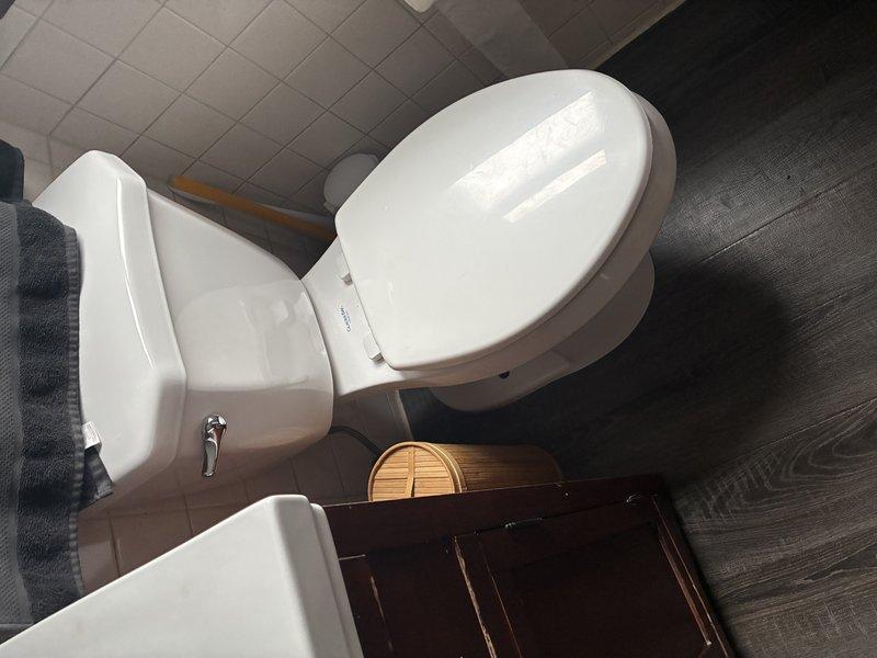 Completed complimentary membership plumbing inspection during requested afternoon timeframe. Conducted thorough examination of accessible plumbing systems including under-sink components and bathroom fixtures. Documented significant corrosion on metal mounting bracket in cabinet area, indicating prolonged moisture exposure that may require future attention. All visible bathroom fixtures including toilet and pedestal sink found in good working condition with no active leaks detected at time of inspection.