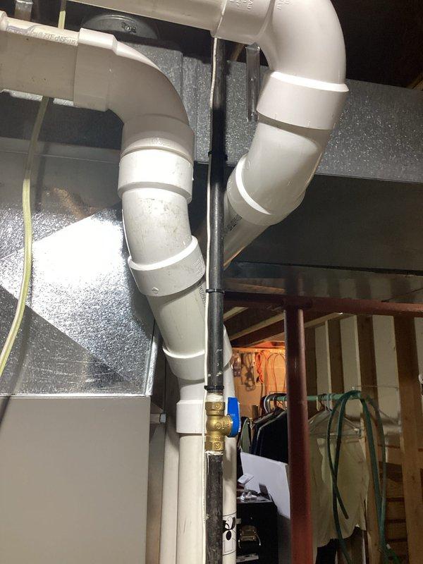 Completed full HVAC system installation in basement mechanical room, including new Lennox furnace unit, air handler, and associated ductwork. Installed white PVC condensate drain piping with proper pitch and trap configuration, secured with appropriate mounting brackets to structural supports. Routed large-diameter supply and return ductwork from furnace to distribution points, ensuring proper connections and sealed joints. All equipment positioned per manufacturer specifications with adequate clearance for service access. System tested and verified operational upon completion.