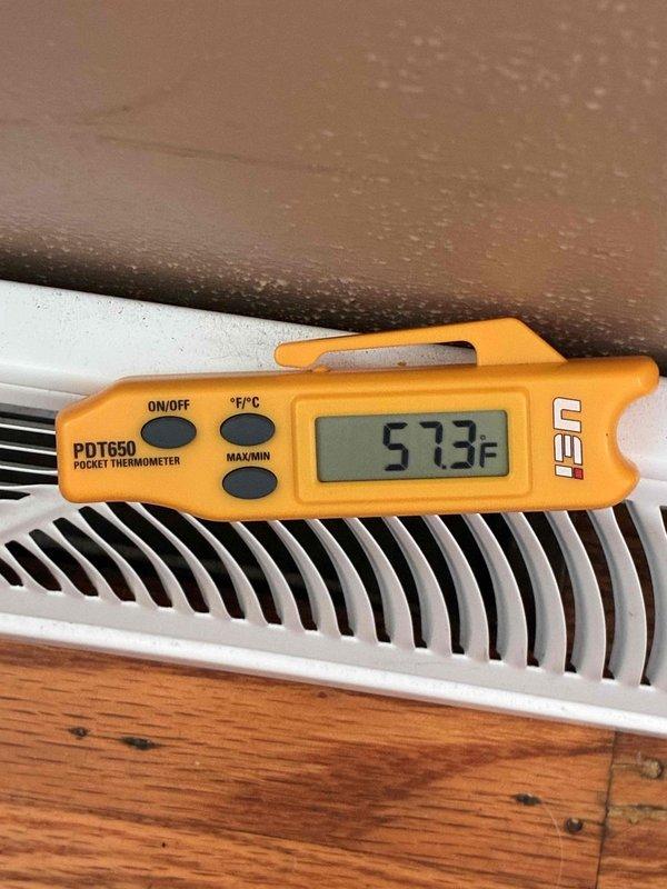 Performed AC system startup on EL18 unit with S40 thermostat, confirming disconnect switch on, service valves open, breaker energized, and system operational. Investigated customer concern regarding furnace vent pipe leaking water into basement during heavy rain events. Inspected ductwork connections and vent termination components in attic space, documenting condition of flexible ductwork, metal duct connections, and end cap assembly with visible dust accumulation and potential weatherproofing concerns.