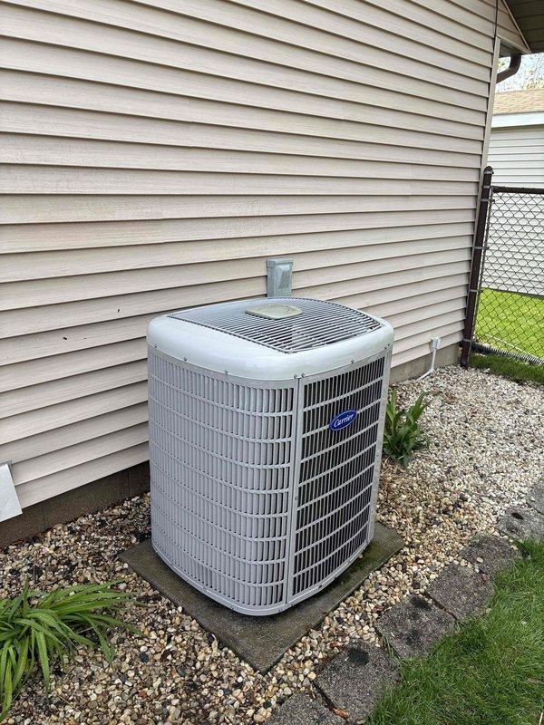 Completed standard AC tune-up maintenance on residential outdoor condensing unit. Unit is operational with proper airflow through condenser coils. Evaporator coil installation documentation was reviewed on-site, indicating CAPVU/CAPVL/CAPVP/CAFVP model specifications for future reference regarding refrigerant piping and metering device connections.