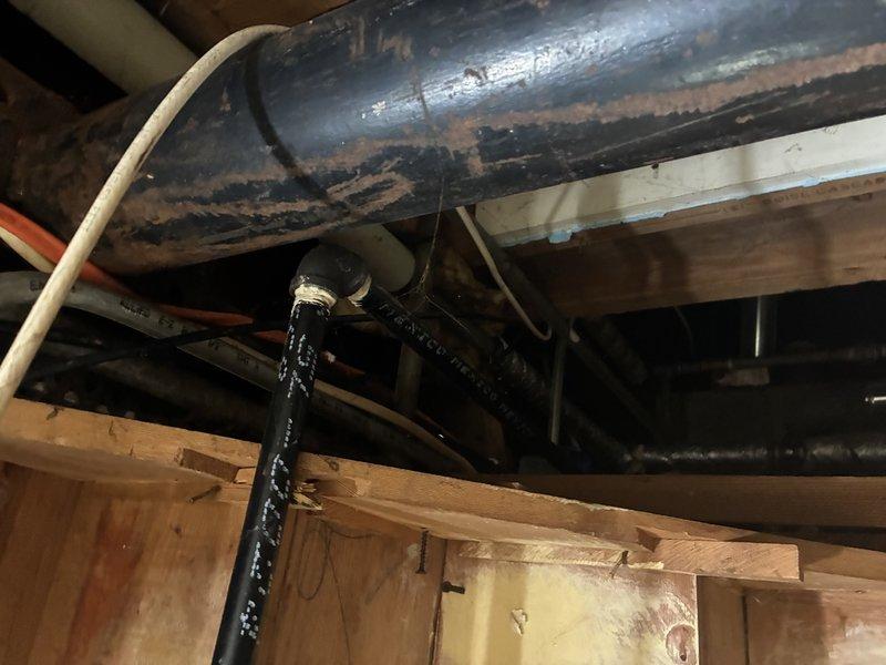 Conducted on-site assessment for sump pump installation in residential property currently lacking basement water management system. Evaluated basement conditions and determined requirements for complete sump pump system including excavation for crock basin installation. Documented existing basement infrastructure including overhead ductwork showing advanced corrosion and deterioration, floor joist configuration, and foundation exterior conditions adjacent to lawn area where discharge line routing would be required.